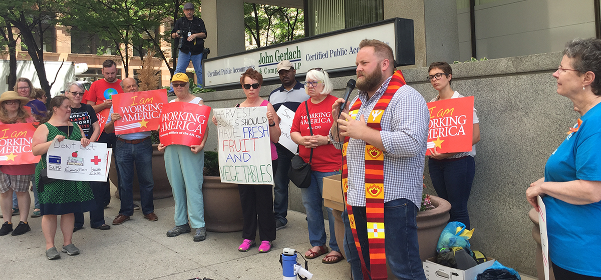 Rev. Dan Clark, Ohio Director for Faith in Public Life, speaking outside the office